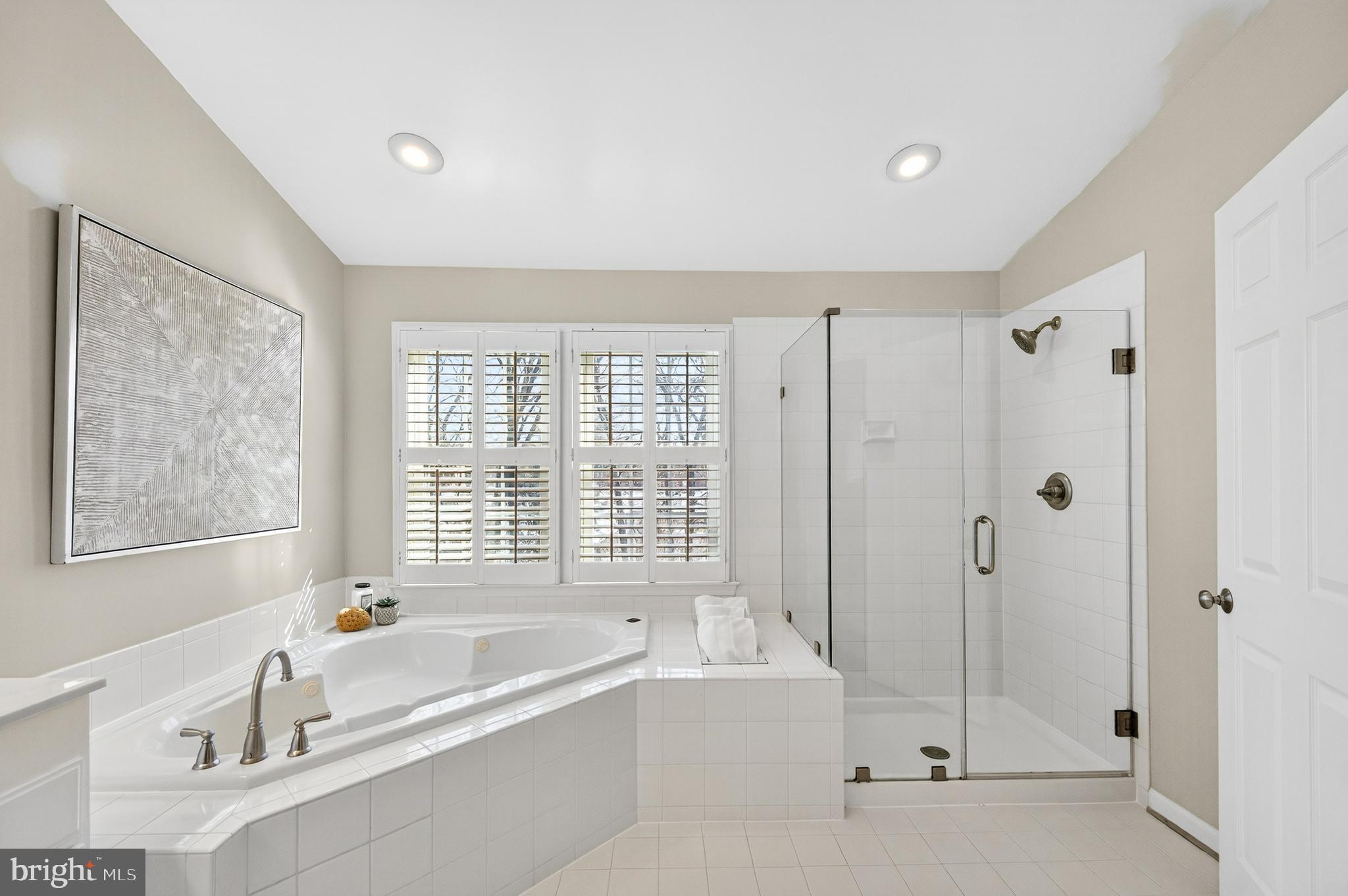2143 Wolftrap Court Vienna, VA 22182 - Photo 29 of 49 a bathroom with a bathtub a shower a sink and a window