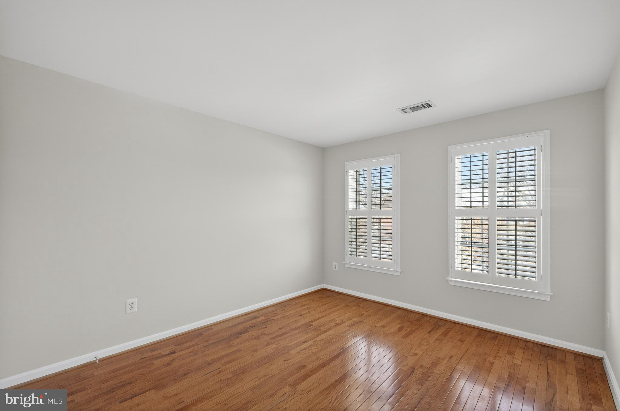 2143 Wolftrap Court Vienna, VA 22182 - Photo 31 of 49 an empty room with wooden floor and windows
