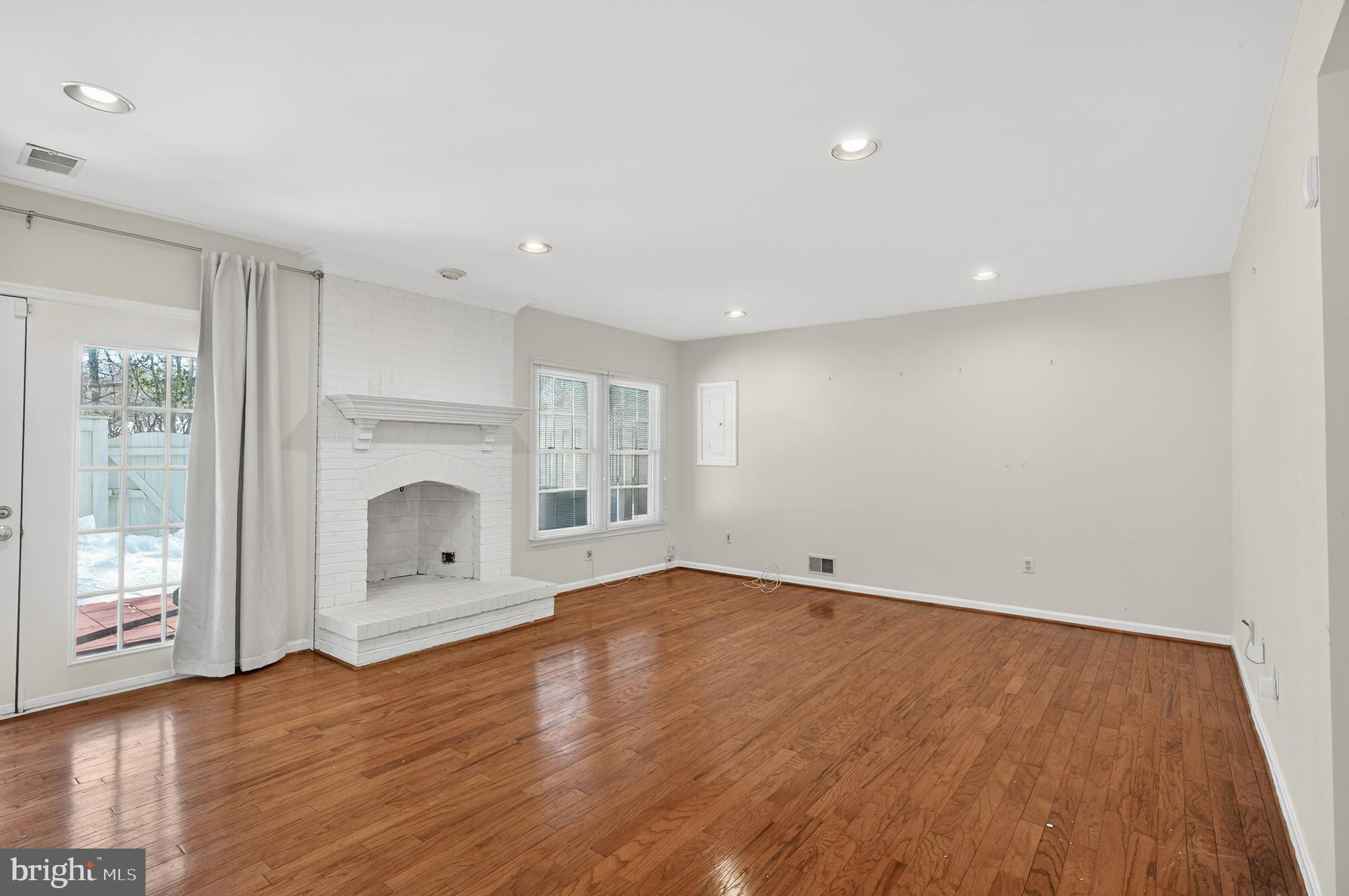 2143 Wolftrap Court Vienna, VA 22182 - Photo 38 of 49 a view of empty room with wooden floor and fireplace