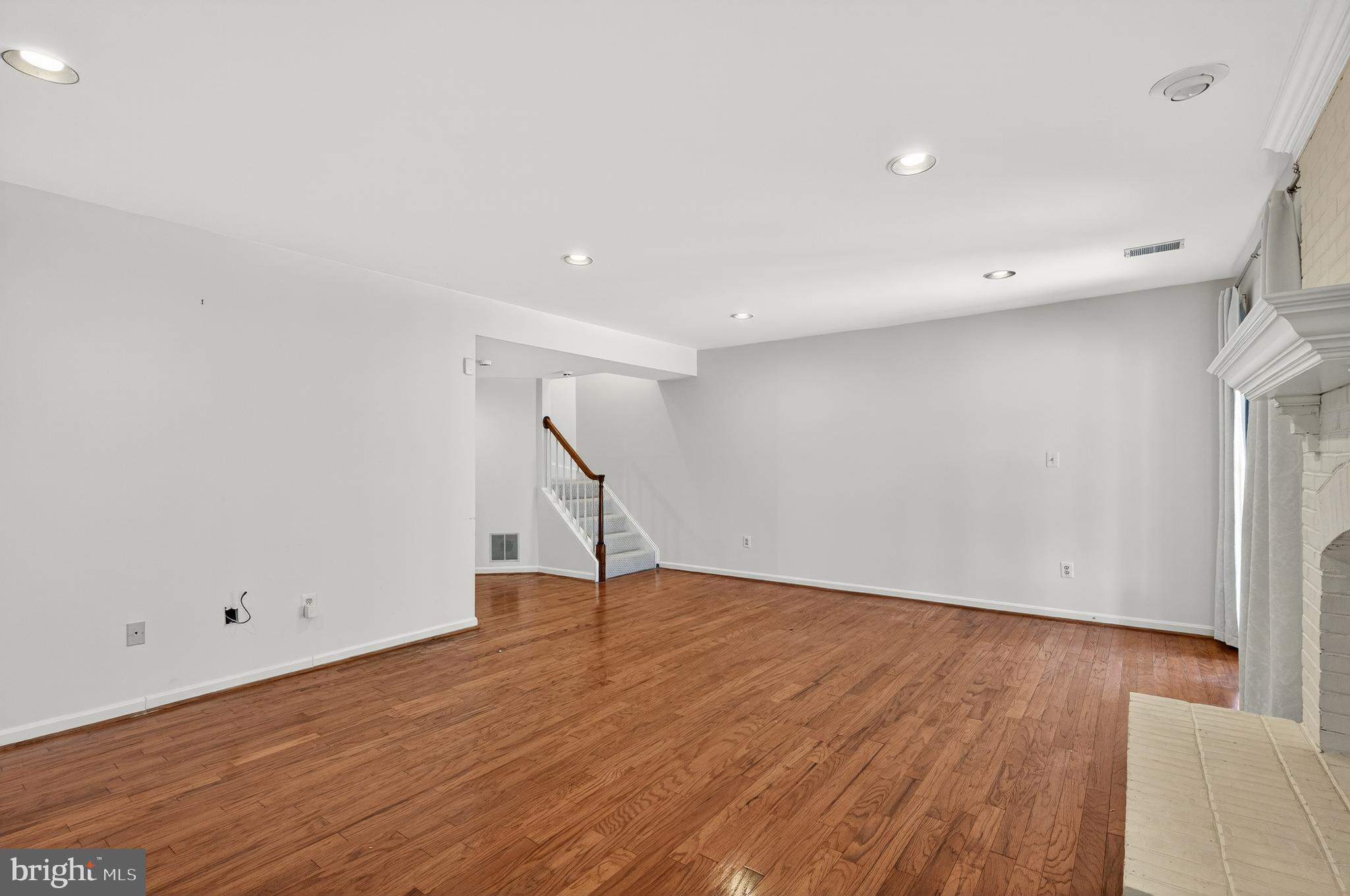 2143 Wolftrap Court Vienna, VA 22182 - Photo 40 of 49 a view of an empty room with wooden floor and a window