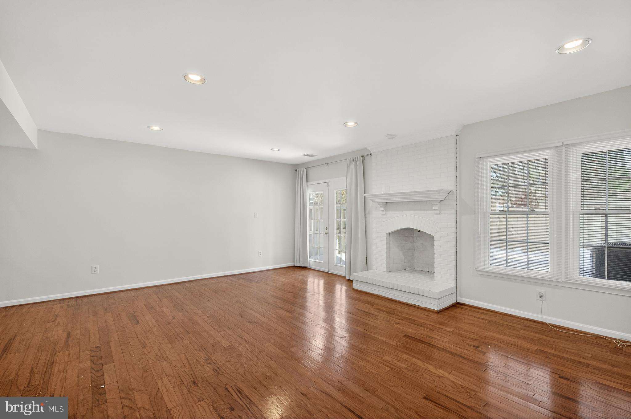 2143 Wolftrap Court Vienna, VA 22182 - Photo 41 of 49 a view of empty room with wooden floor and fireplace