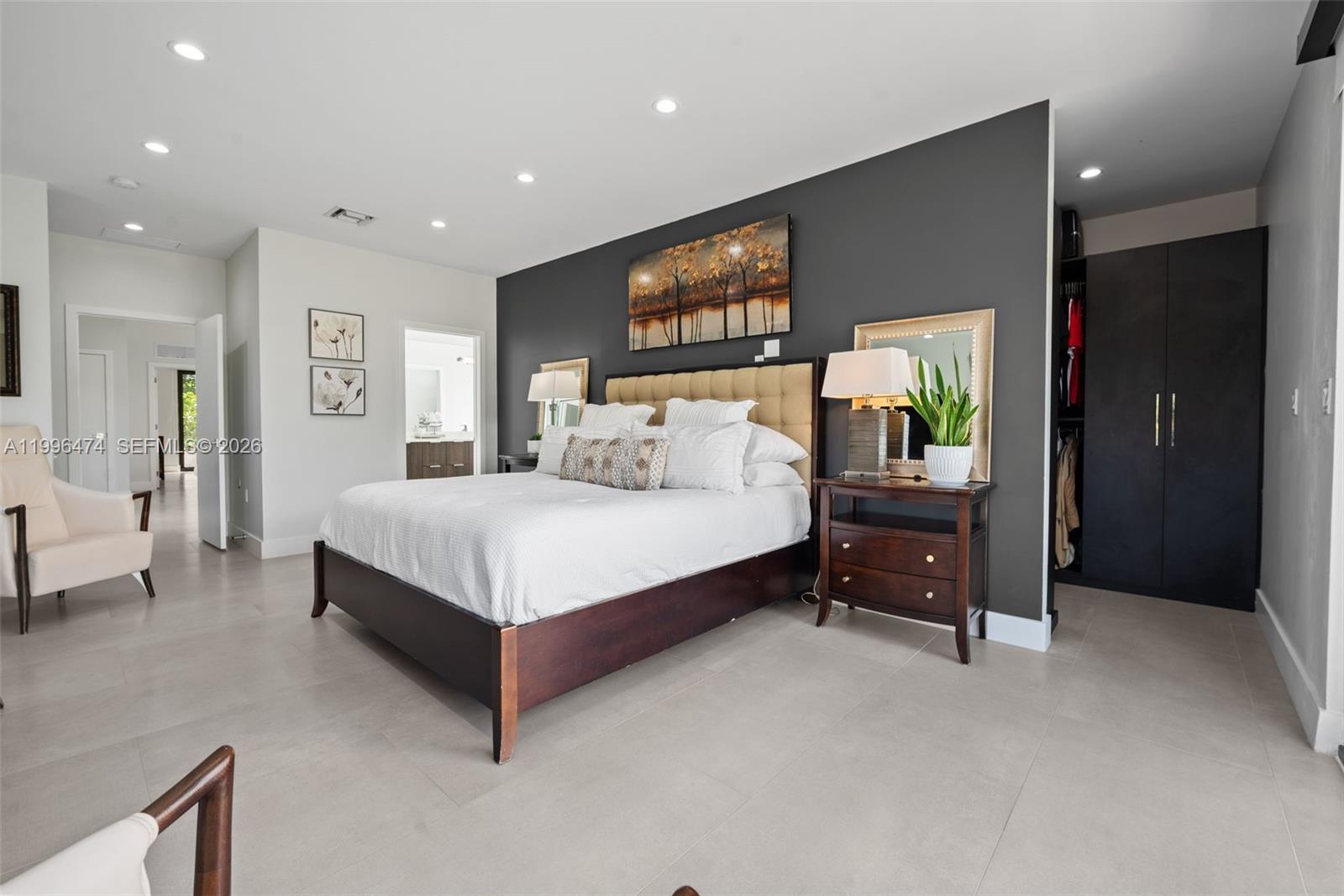 5735 Southwest 35th Street Miami, FL 33155 - Photo 15 of 30 a spacious bedroom with a bed and a dresser in it