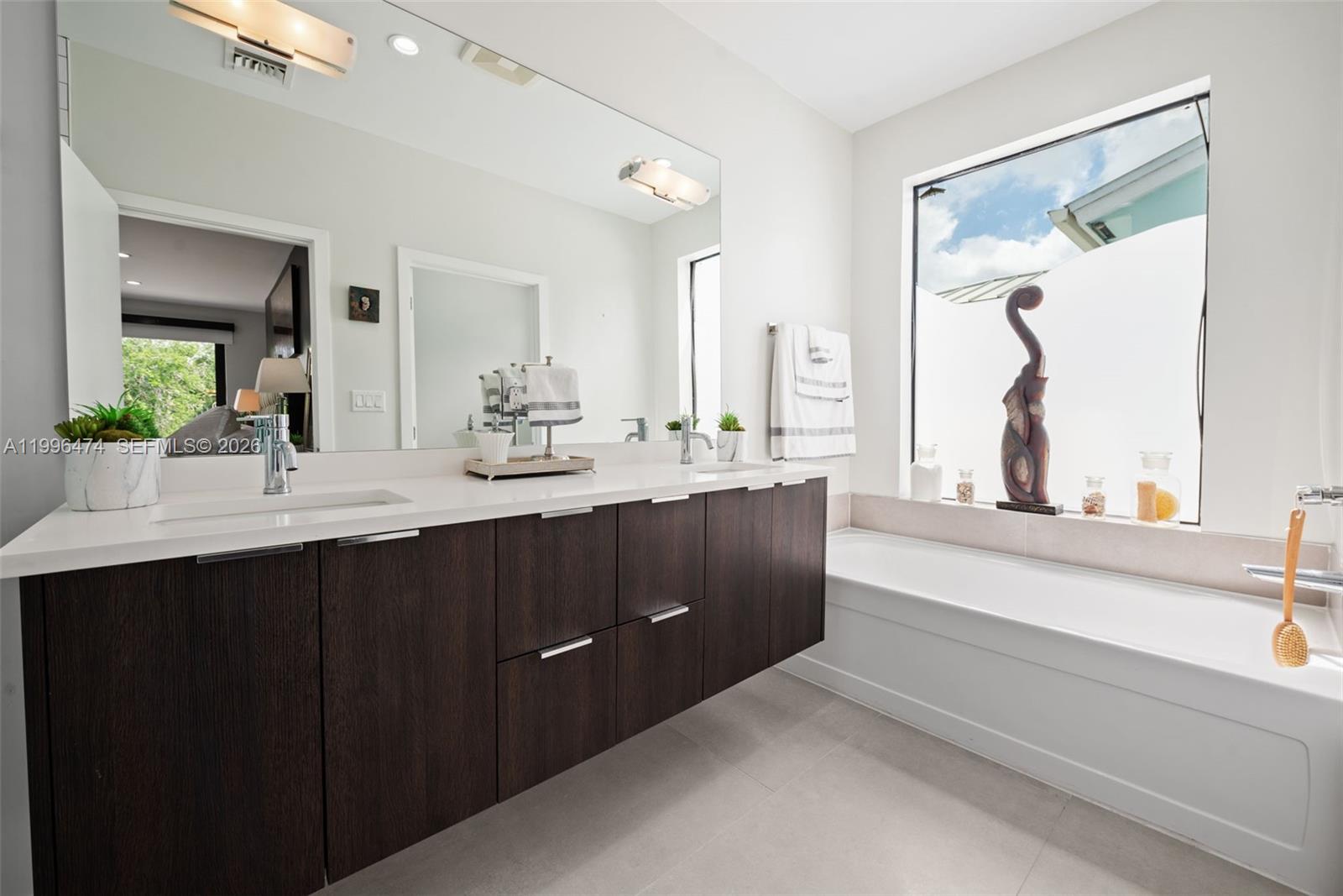 5735 Southwest 35th Street Miami, FL 33155 - Photo 17 of 30 a bathroom with a double vanity sink and mirror