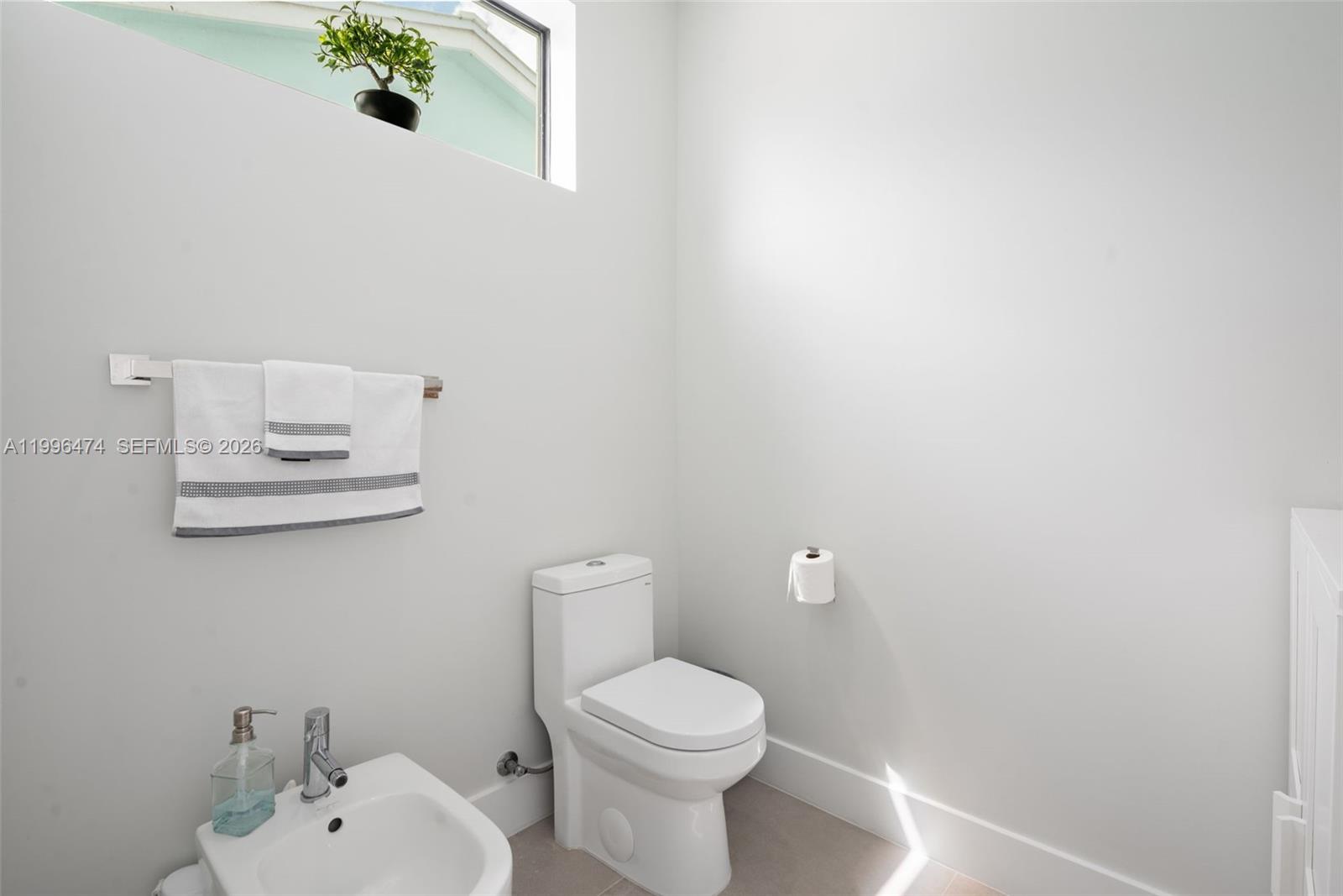 5735 Southwest 35th Street Miami, FL 33155 - Photo 19 of 30 a white toilet sitting next to a white sink