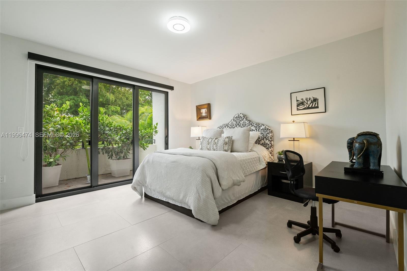 5735 Southwest 35th Street Miami, FL 33155 - Photo 20 of 30 a spacious bedroom with a bed and a large window