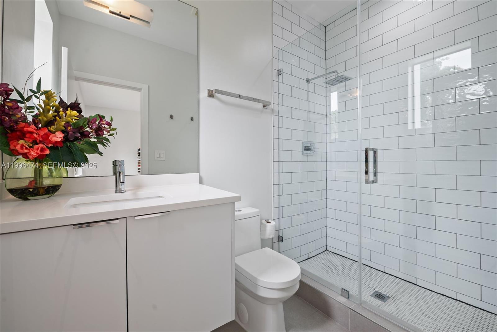5735 Southwest 35th Street Miami, FL 33155 - Photo 22 of 30 a bathroom with a sink a toilet and shower