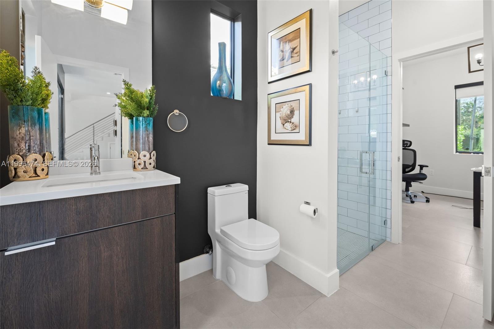 5735 Southwest 35th Street Miami, FL 33155 - Photo 26 of 30 a bathroom with a toilet sink and shower