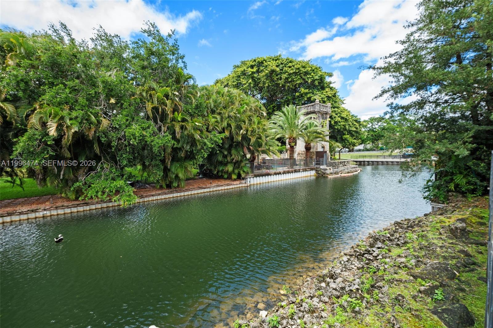 5735 Southwest 35th Street Miami, FL 33155 - Photo 28 of 30 a view of a lake with a yard and large trees