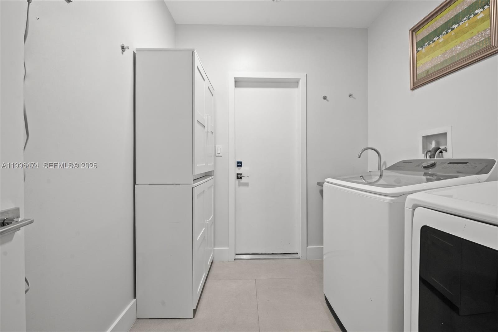 5735 Southwest 35th Street Miami, FL 33155 - Photo 8 of 30 a utility room with cabinets washer and dryer