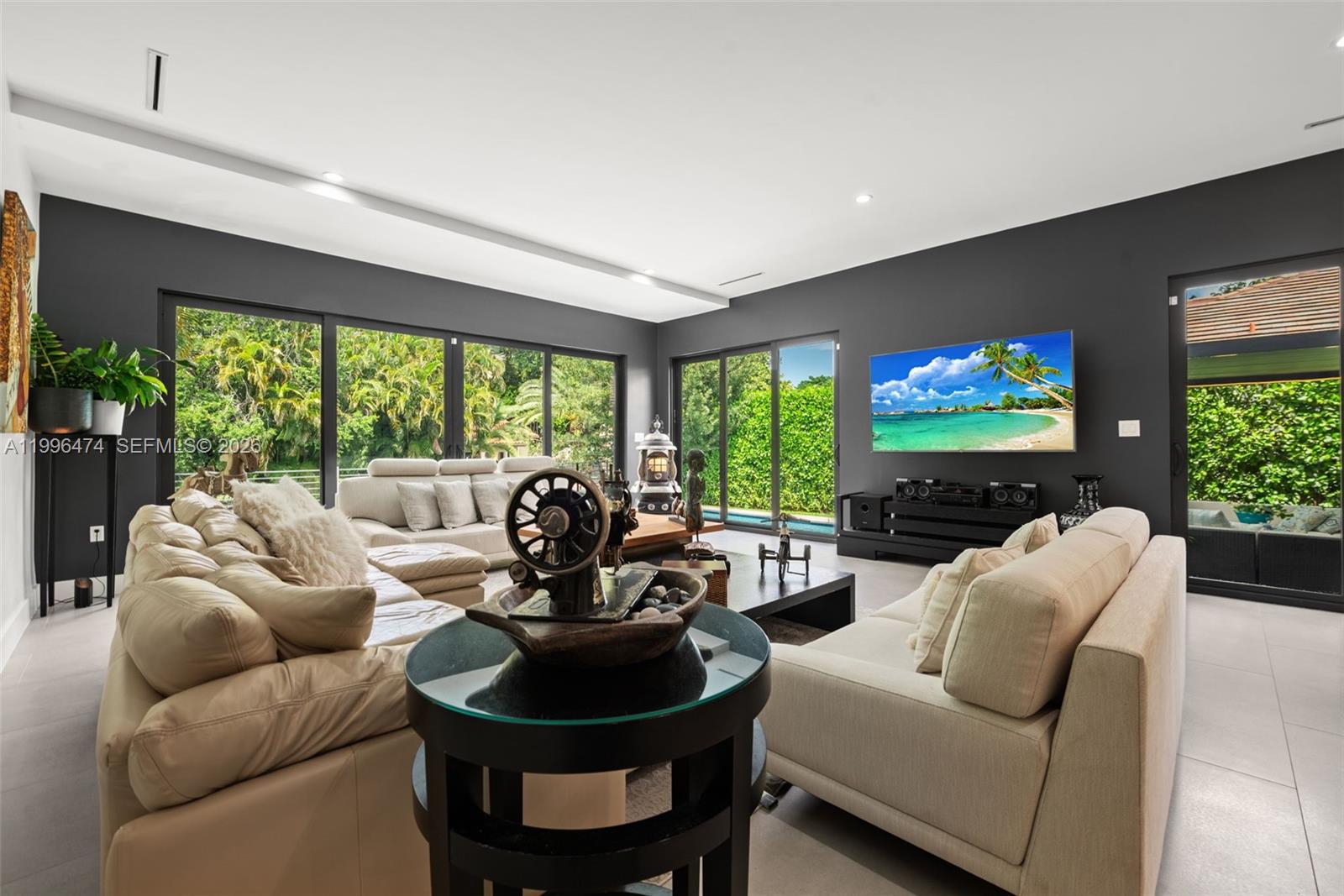 5735 Southwest 35th Street Miami, FL 33155 - Photo 10 of 30 a living room with furniture a floor to ceiling window and a flat screen tv