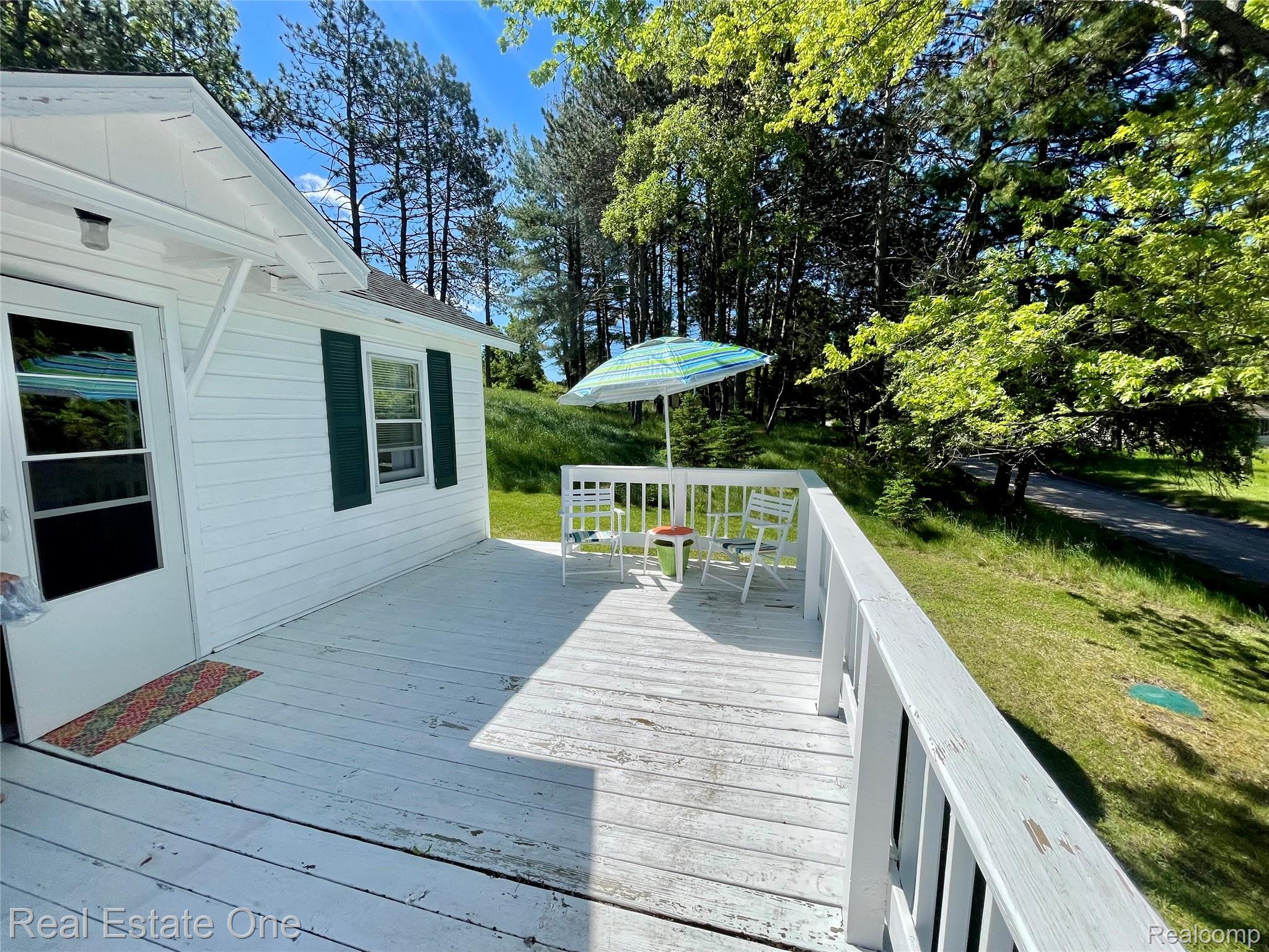 4160 Hawk Road Lincoln, MI 48742 - Photo 10 of 48 Spacious outdoor deck with white painted railings and direct access to the interior