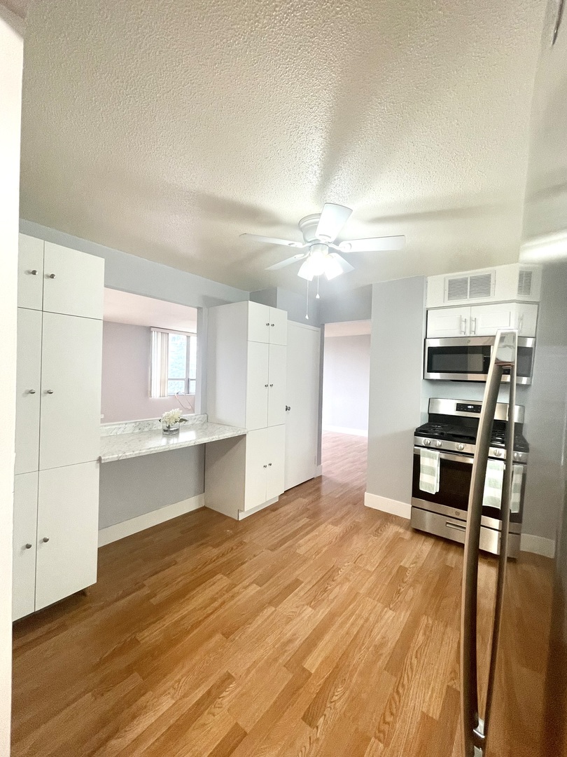 8801 West Golf Road, Unit 3H Niles, IL 60714 - Photo 19 of 33 a room with a bed and furniture
