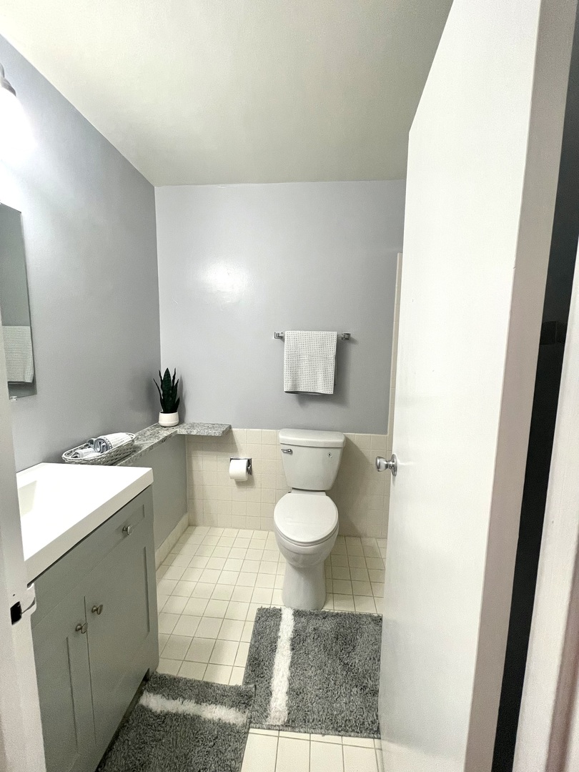 8801 West Golf Road, Unit 3H Niles, IL 60714 - Photo 23 of 33 a bathroom with a granite countertop sink toilet and a mirror
