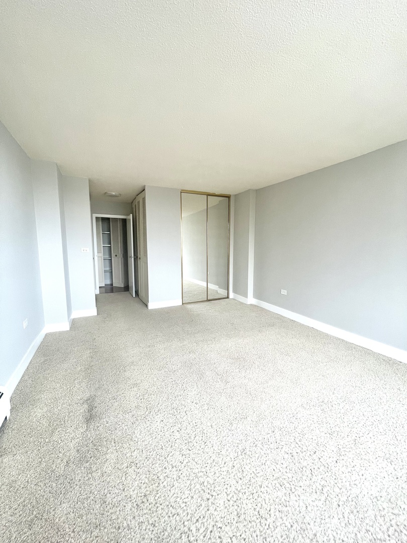 8801 West Golf Road, Unit 3H Niles, IL 60714 - Photo 27 of 33 a view of an empty room with a window