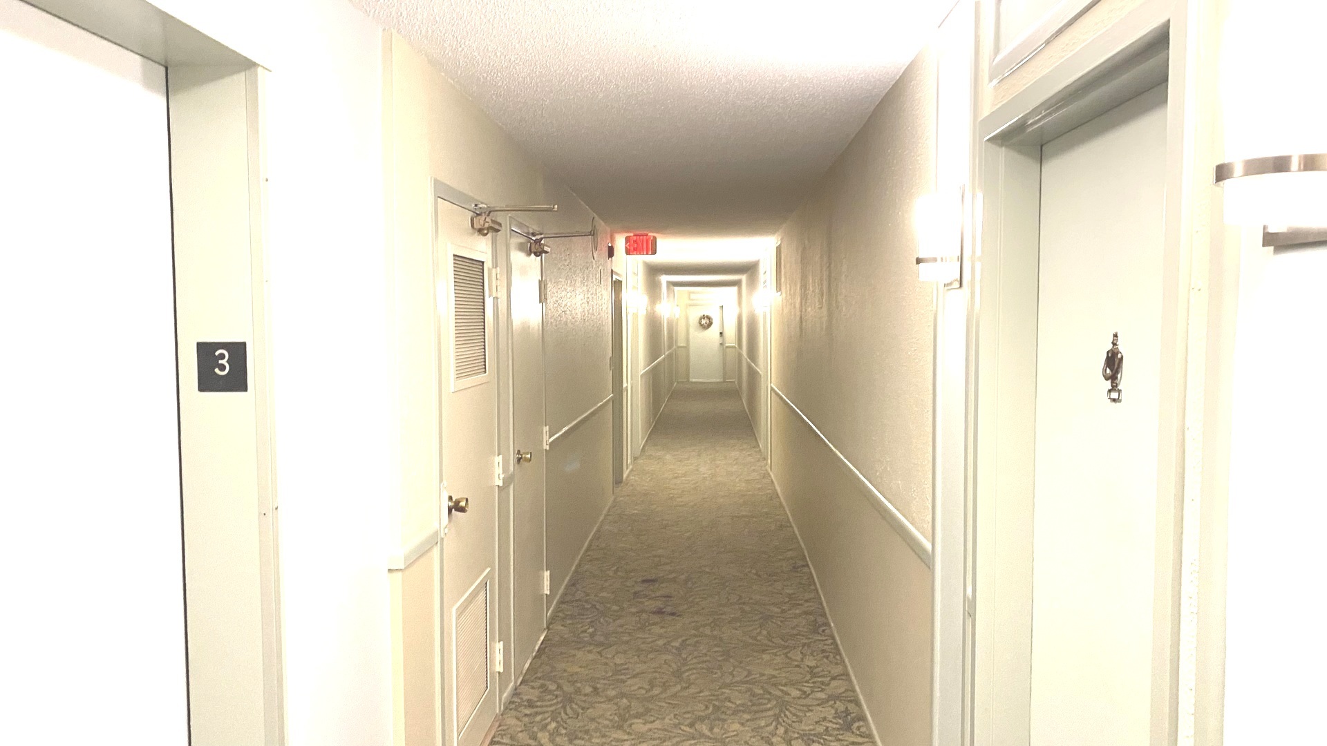 8801 West Golf Road, Unit 3H Niles, IL 60714 - Photo 9 of 33 a view of a hallway with wooden floor