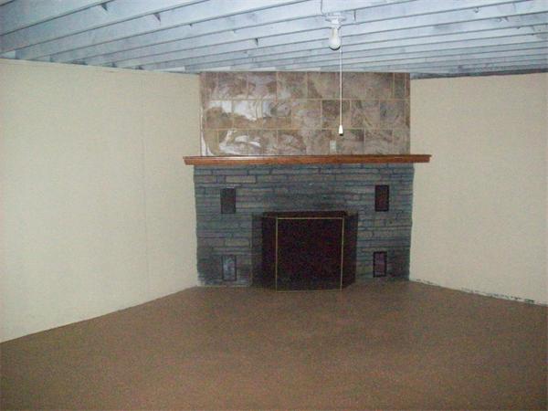 62 Palmer Road Monson, MA 01057 - Photo 14 of 17 a view of an empty room with a fireplace