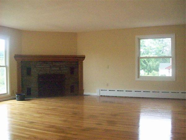 62 Palmer Road Monson, MA 01057 - Photo 4 of 17 an empty room with a fireplace