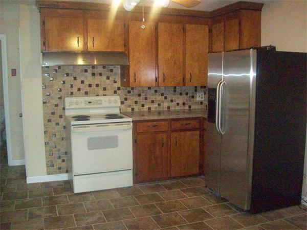 62 Palmer Road Monson, MA 01057 - Photo 7 of 17 a kitchen with cabinets and stainless steel appliances