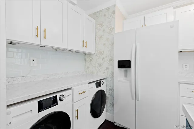 a utility room with sink dryer and washer