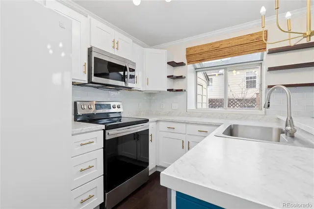 a view of a kitchen with wooden floor and electronic appliances