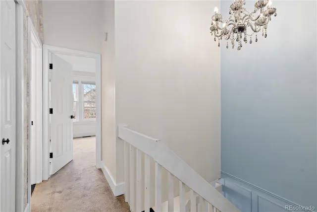 a view of a brick house with a large window and wooden fence