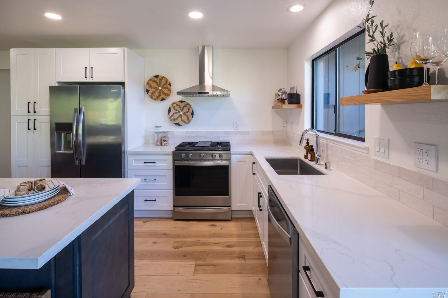 5757 Lucas Valley Road Nicasio, CA 94946 - Photo 13 of 60 a kitchen with stainless steel appliances a sink dishwasher stove and refrigerator