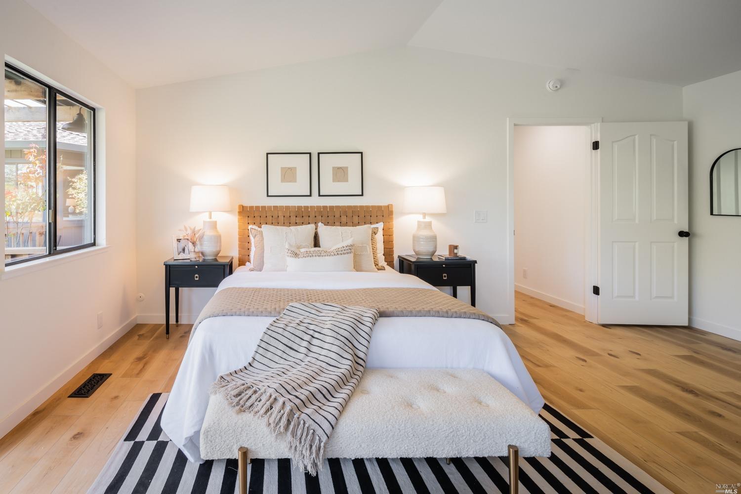 5757 Lucas Valley Road Nicasio, CA 94946 - Photo 16 of 60 a bedroom with a bed and wooden floor