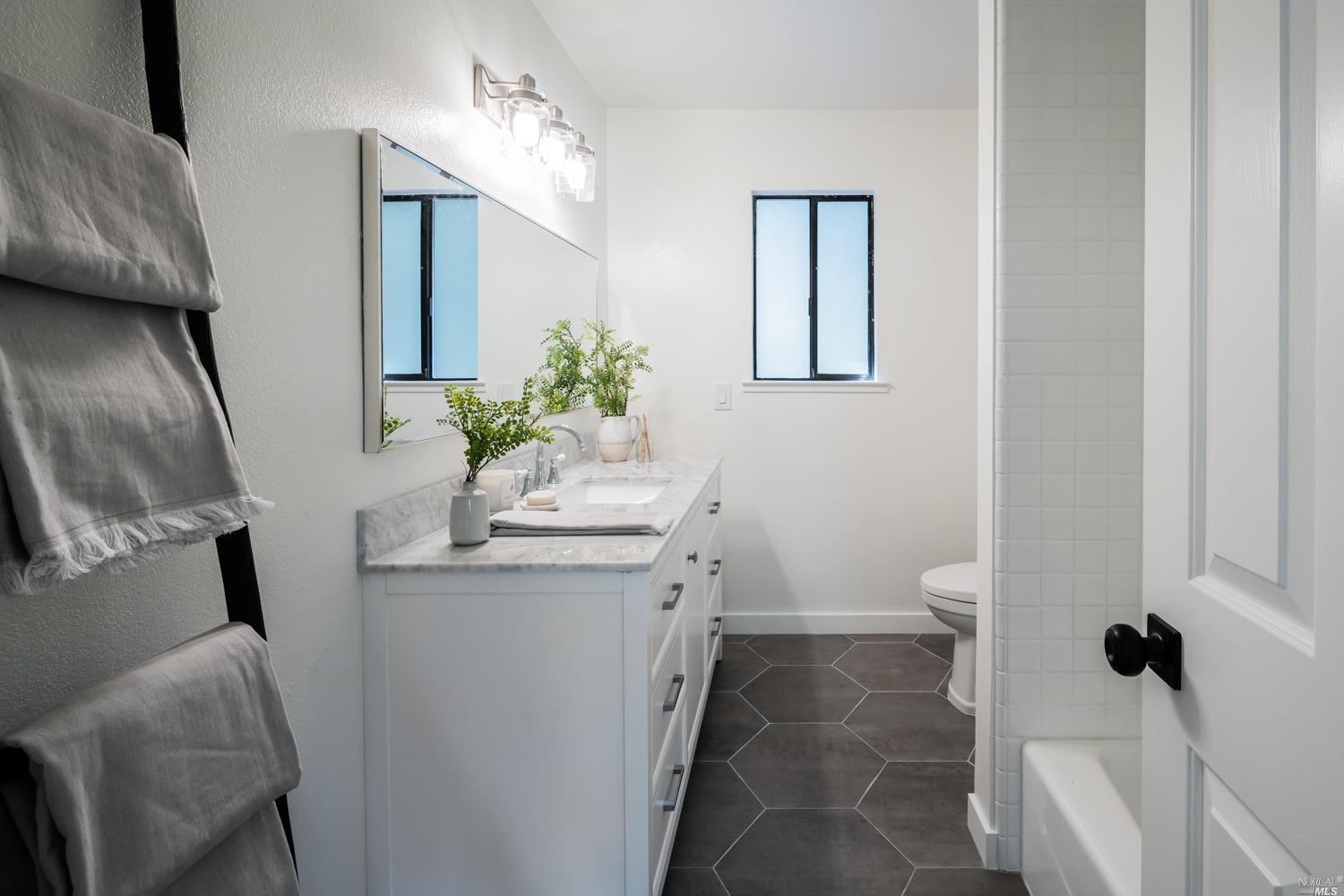 5757 Lucas Valley Road Nicasio, CA 94946 - Photo 18 of 60 a bathroom with a granite countertop sink and a mirror
