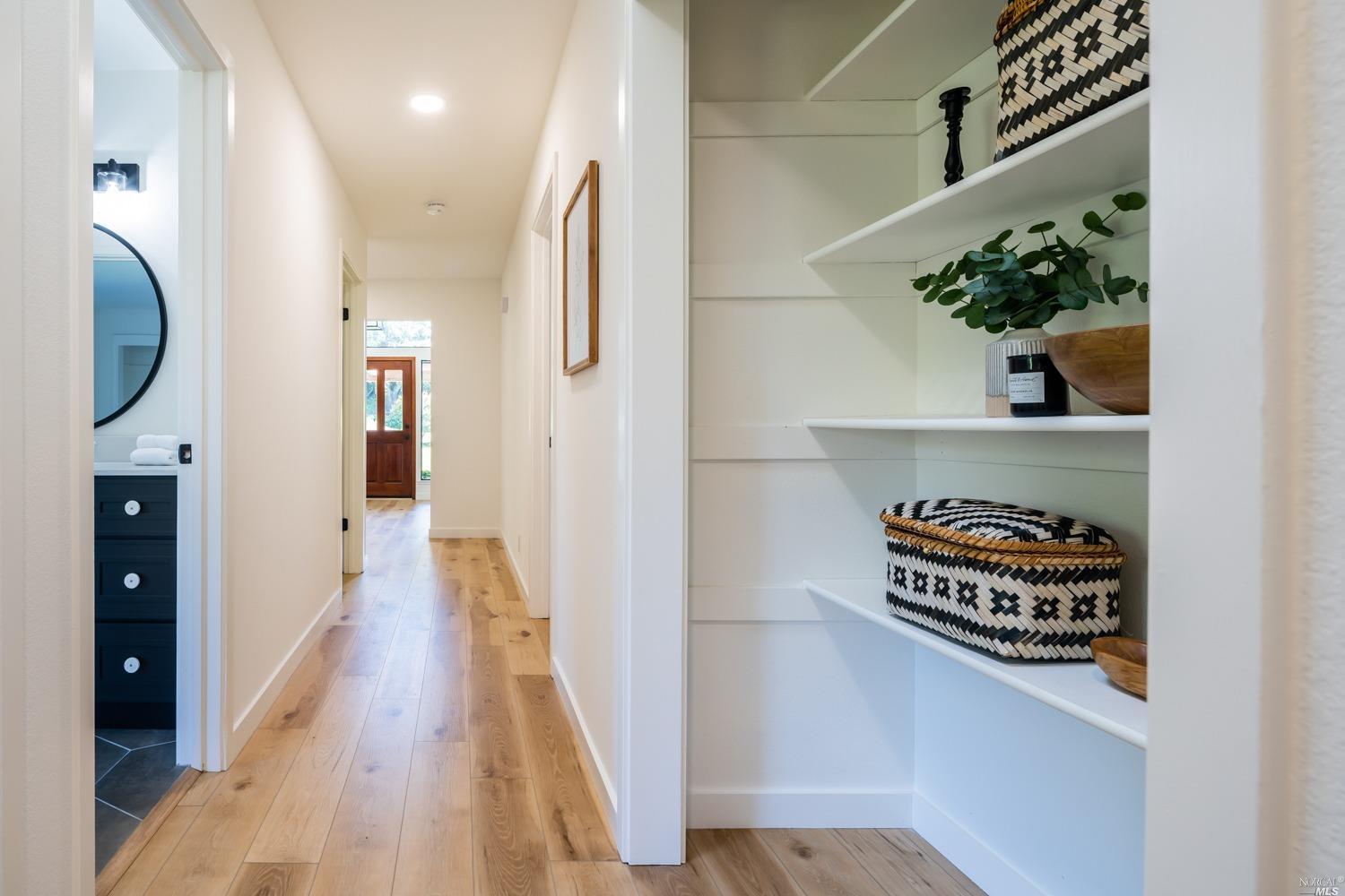 5757 Lucas Valley Road Nicasio, CA 94946 - Photo 19 of 60 a hallway with painting on the wall and a potted plant