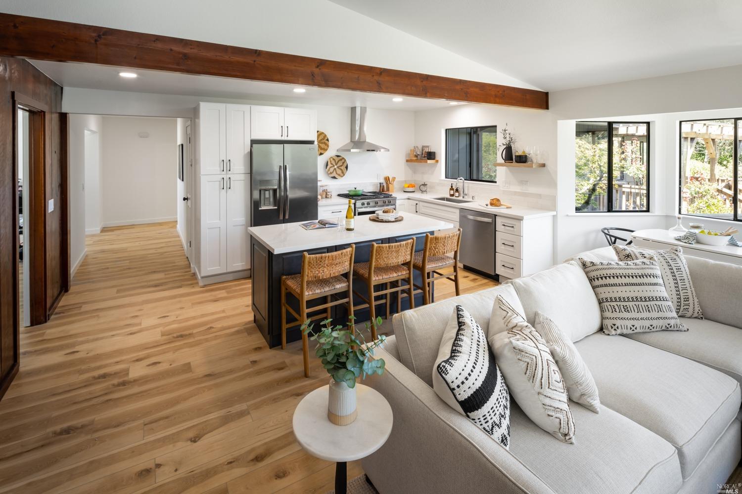 5757 Lucas Valley Road Nicasio, CA 94946 - Photo 8 of 60 a living room with furniture kitchen view and a wooden floor
