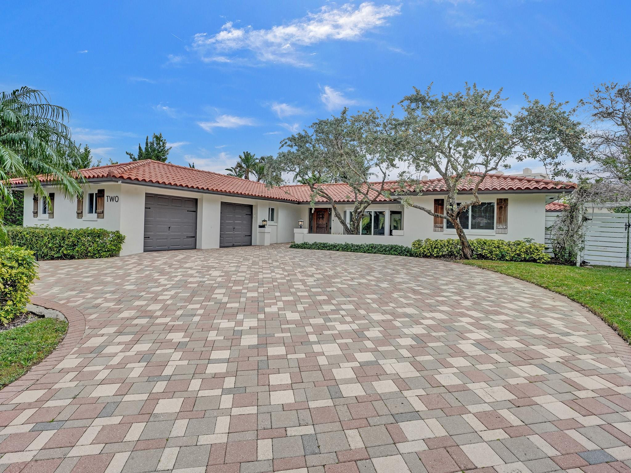 2 Minnetonka Road Sea Ranch Lakes, FL 33308 - Photo 1 of 43 a front view of a house with a yard