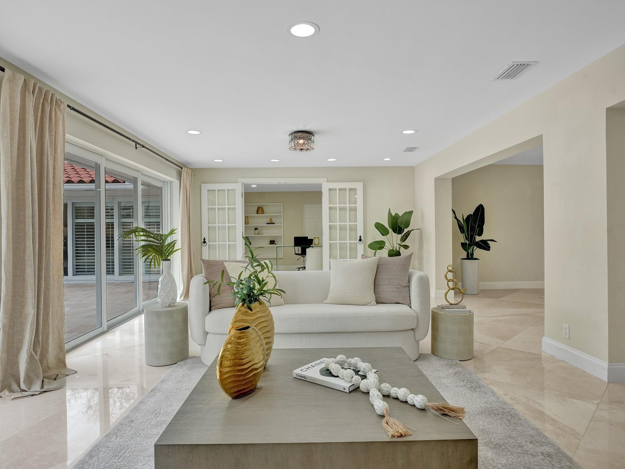 2 Minnetonka Road Sea Ranch Lakes, FL 33308 - Photo 11 of 43 a living room with furniture and a potted plant