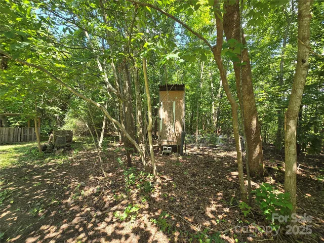 a backyard of a house with lots of trees