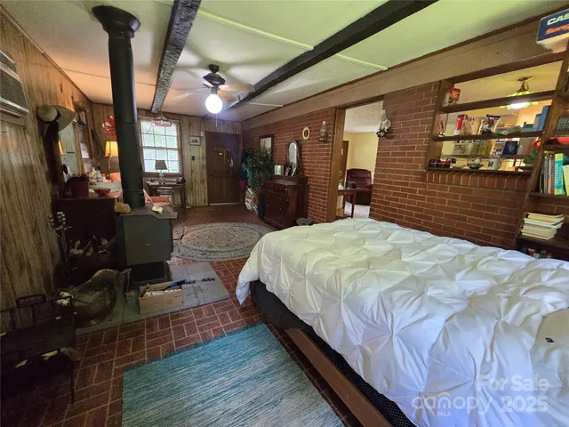 a large bedroom with wooden floor