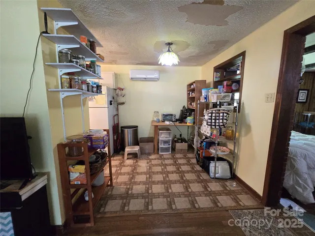 a living room with furniture a dining table and a piano
