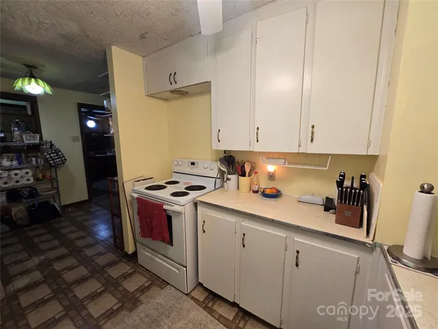a kitchen with a stove and cabinets