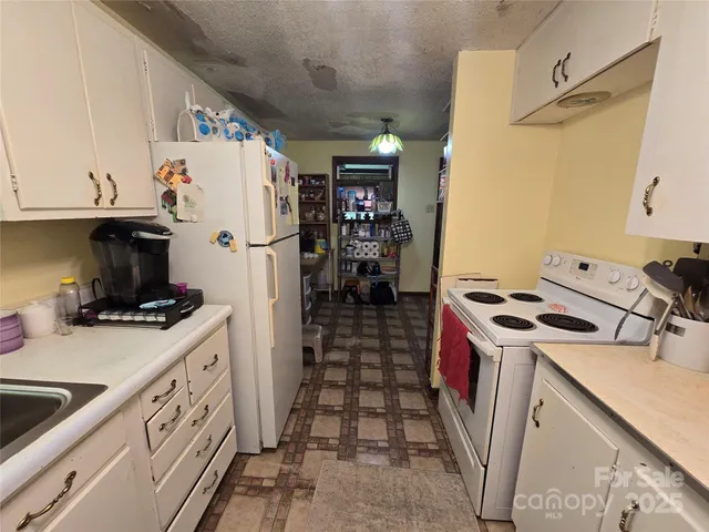 a kitchen with a stove and a refrigerator