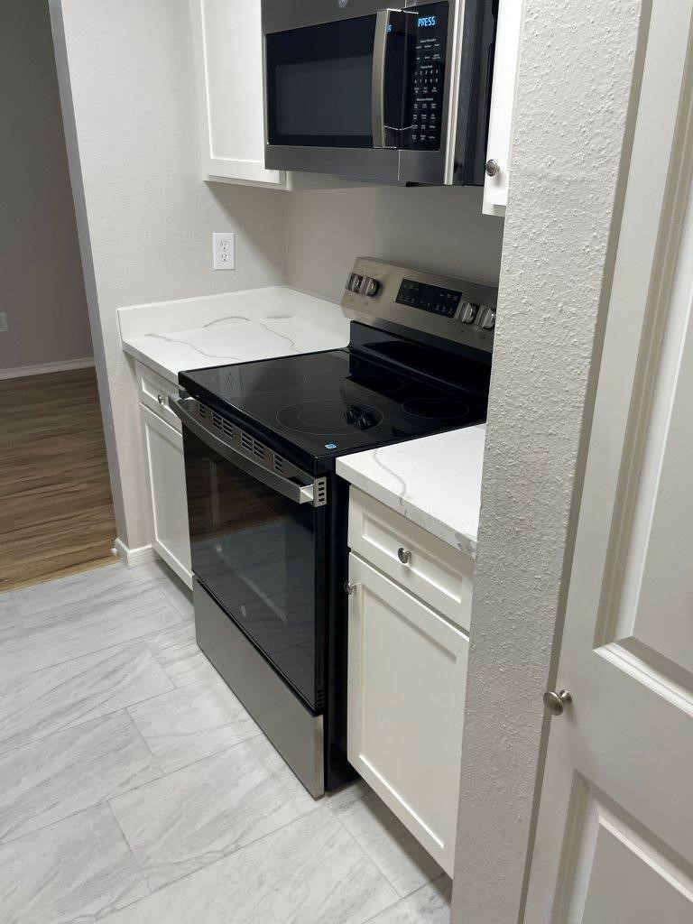 3608 Ocee Street Houston, TX 77063 - Photo 12 of 31 a kitchen with a stove and a microwave