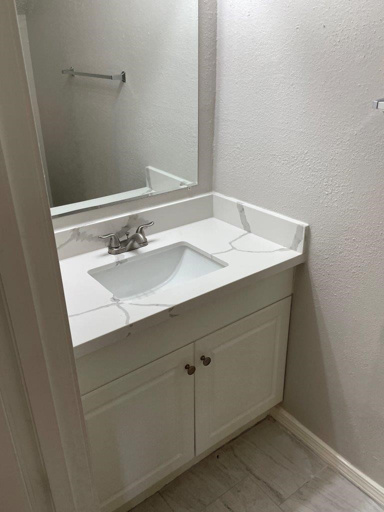 3608 Ocee Street Houston, TX 77063 - Photo 17 of 31 a bathroom with a sink and a mirror