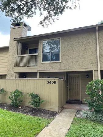 a view of a house with a yard and plants