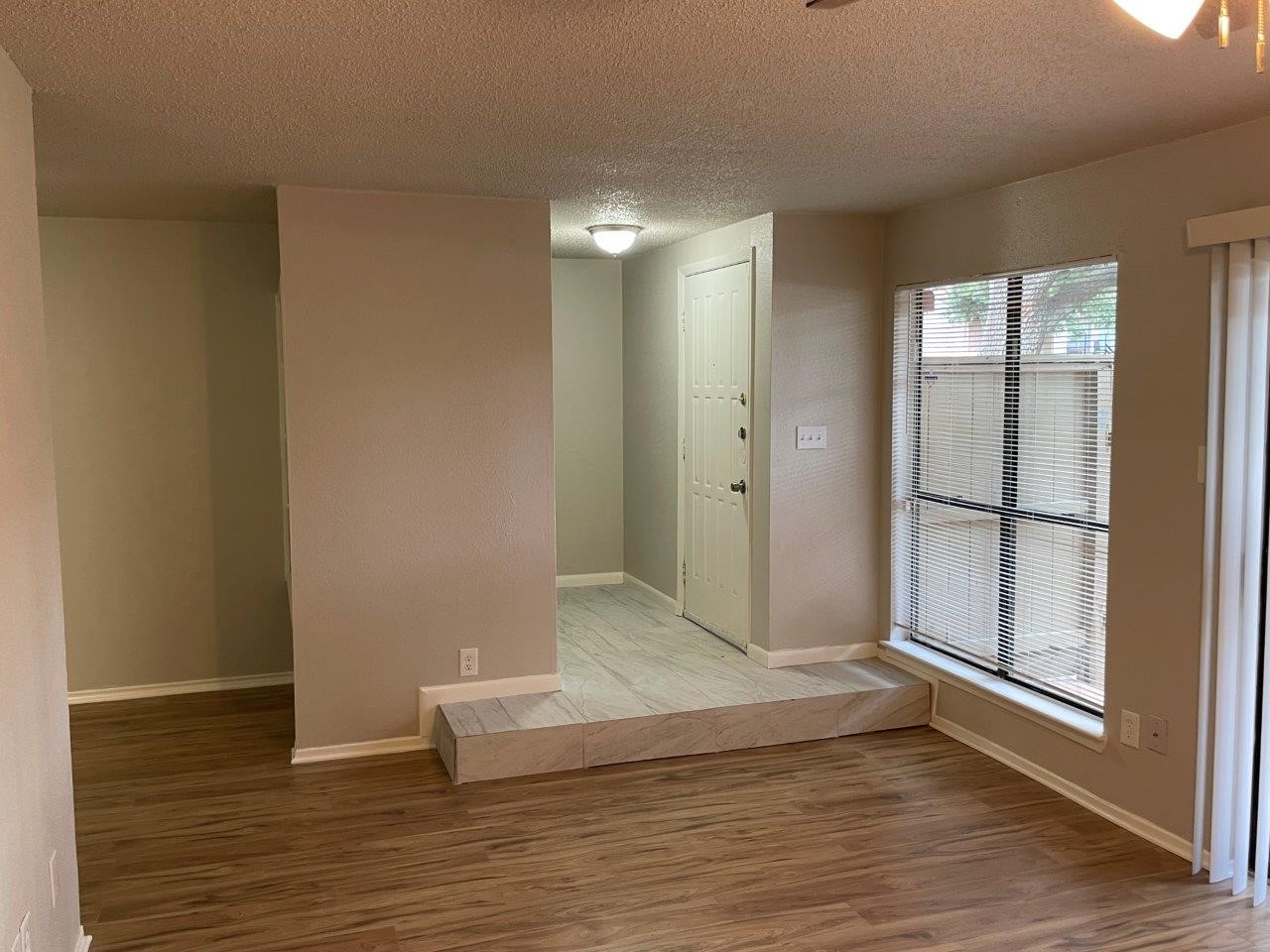 3608 Ocee Street Houston, TX 77063 - Photo 4 of 31 a view of an empty room with wooden floor and a window