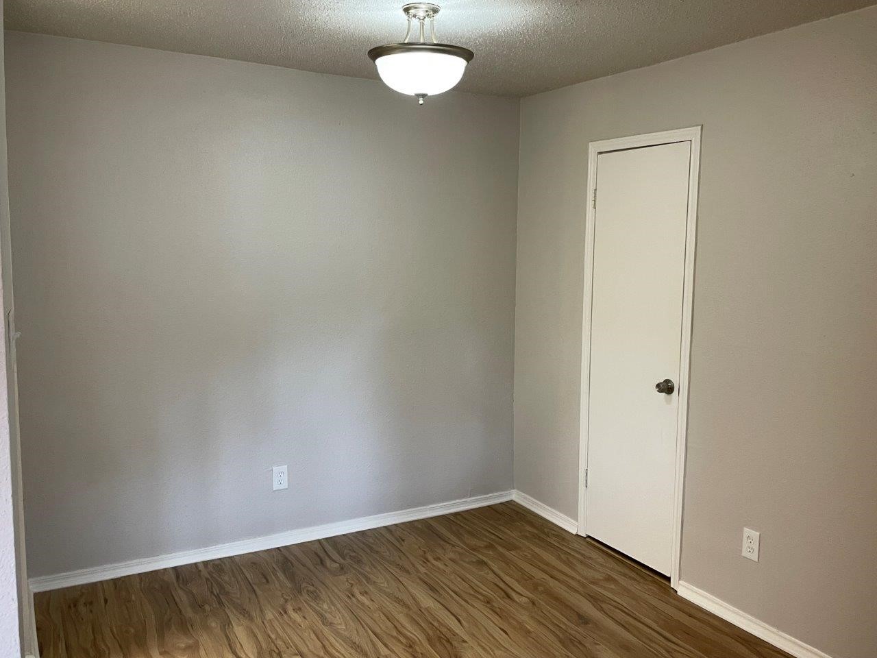 3608 Ocee Street Houston, TX 77063 - Photo 6 of 31 an empty room with wooden floor and windows