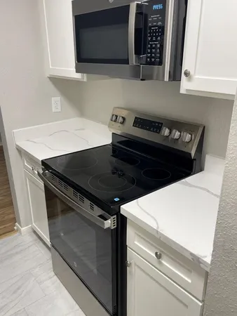 a close view of a sink a refrigerator and window