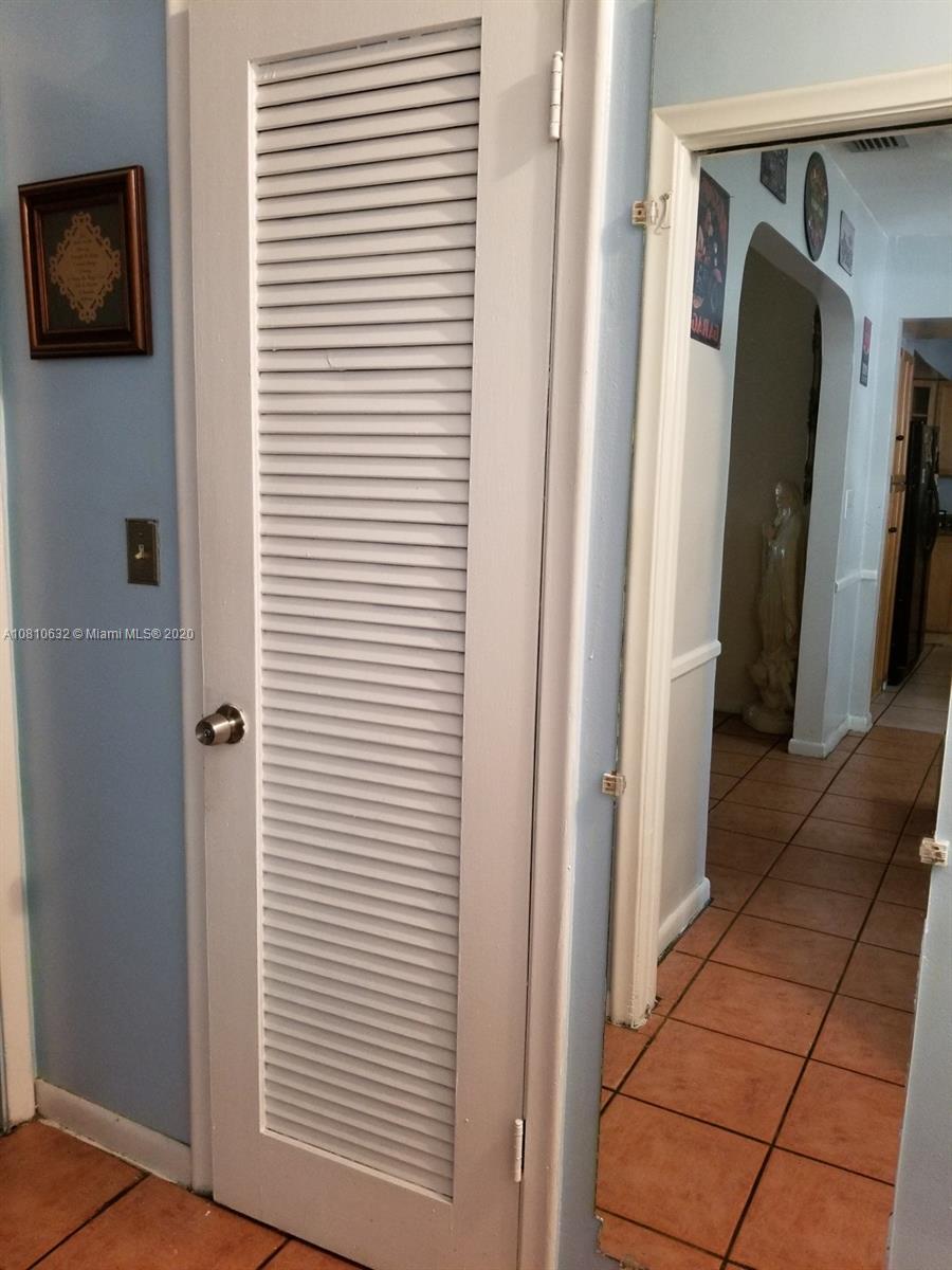 2001 North Park Road Hollywood, FL 33021 - Photo 21 of 49 walk in closet in master suite hall, mirror in hall