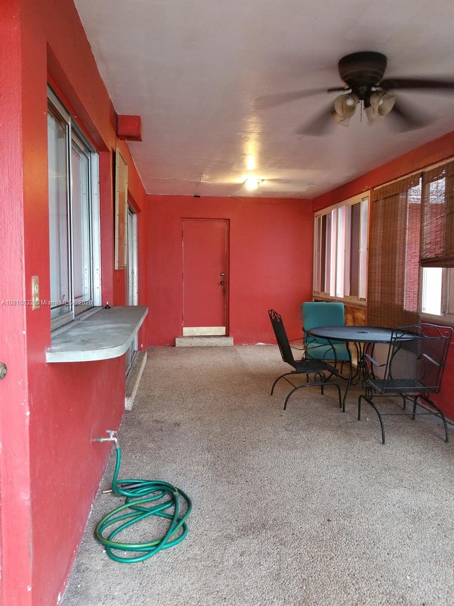 2001 North Park Road Hollywood, FL 33021 - Photo 30 of 49 enclosed porch (has sliding windows that open/close) from kitchen leads to laundry room & garage and back yard. Chattahoochee stone porch floor.