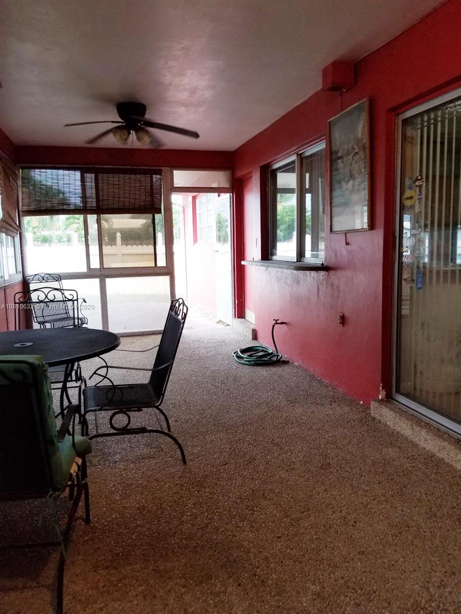 2001 North Park Road Hollywood, FL 33021 - Photo 31 of 49 enclosed porch, has sliding windows to open/close. Leads to back yard and laundry room & garage.