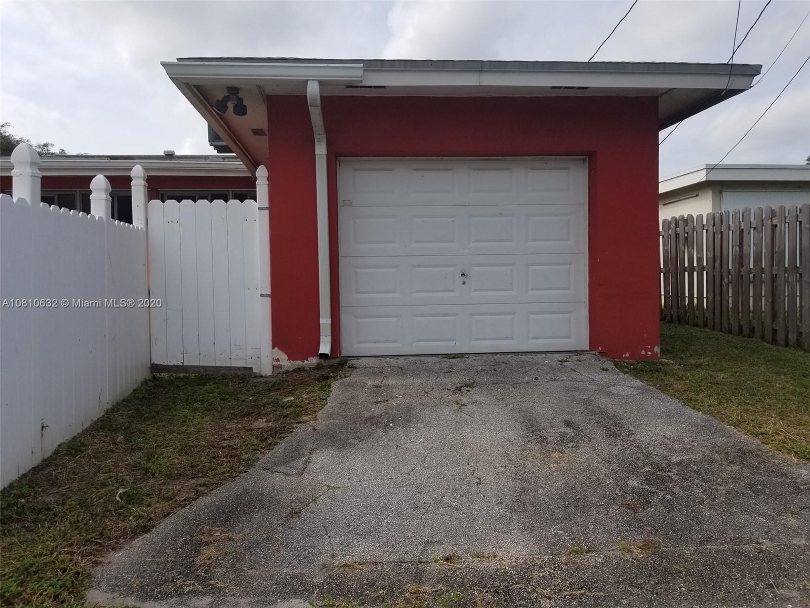 2001 North Park Road Hollywood, FL 33021 - Photo 41 of 49 rear driveway to one car garage from alley behind house