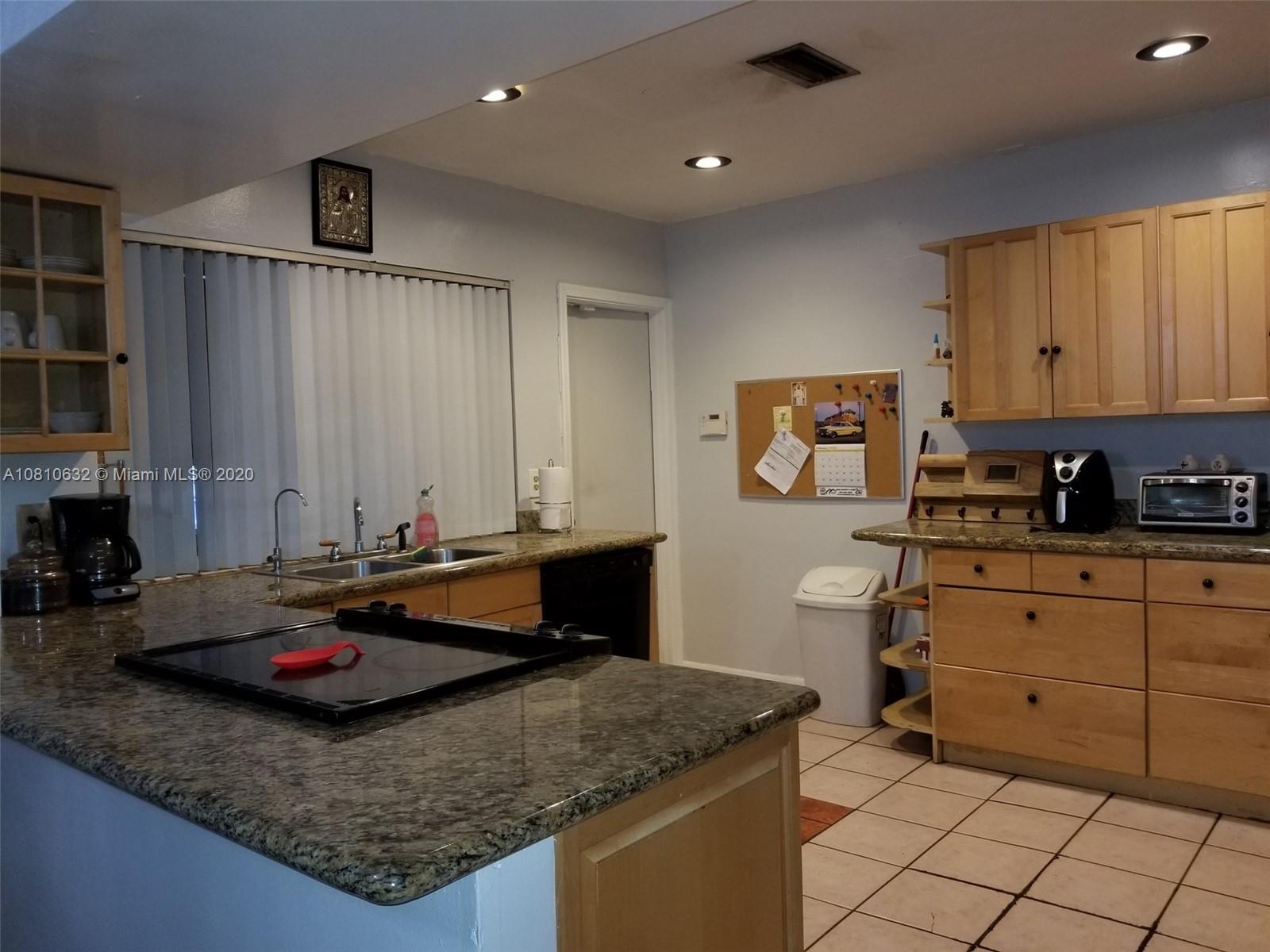 2001 North Park Road Hollywood, FL 33021 - Photo 8 of 49 open kitchen to dining room, door to enclosed porch