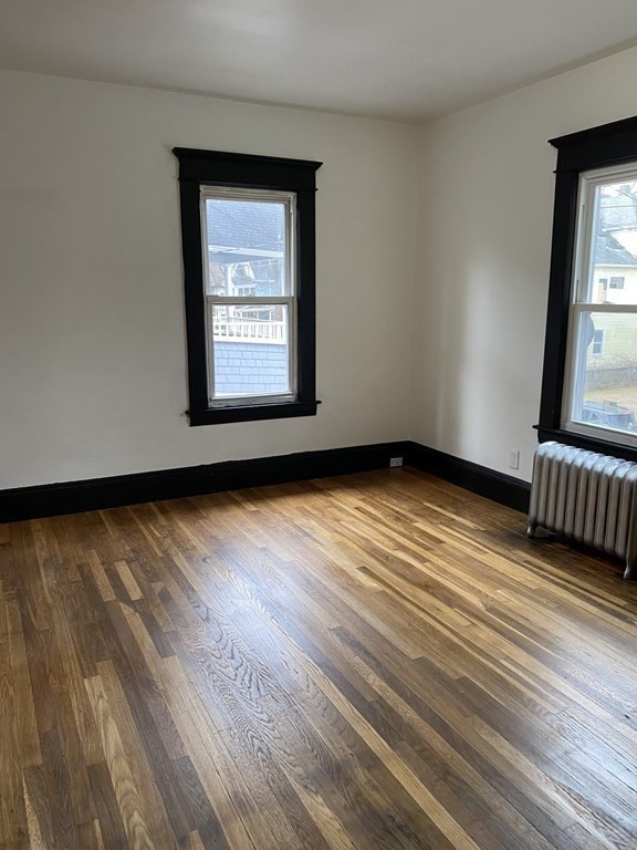 41-43 Lester Street Springfield, MA 01108 - Photo 17 of 25 a view of an empty room with wooden floor and a window