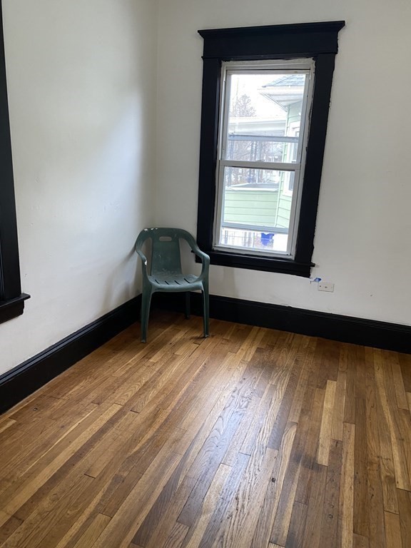 41-43 Lester Street Springfield, MA 01108 - Photo 19 of 25 a view of a room with wooden floor and a window
